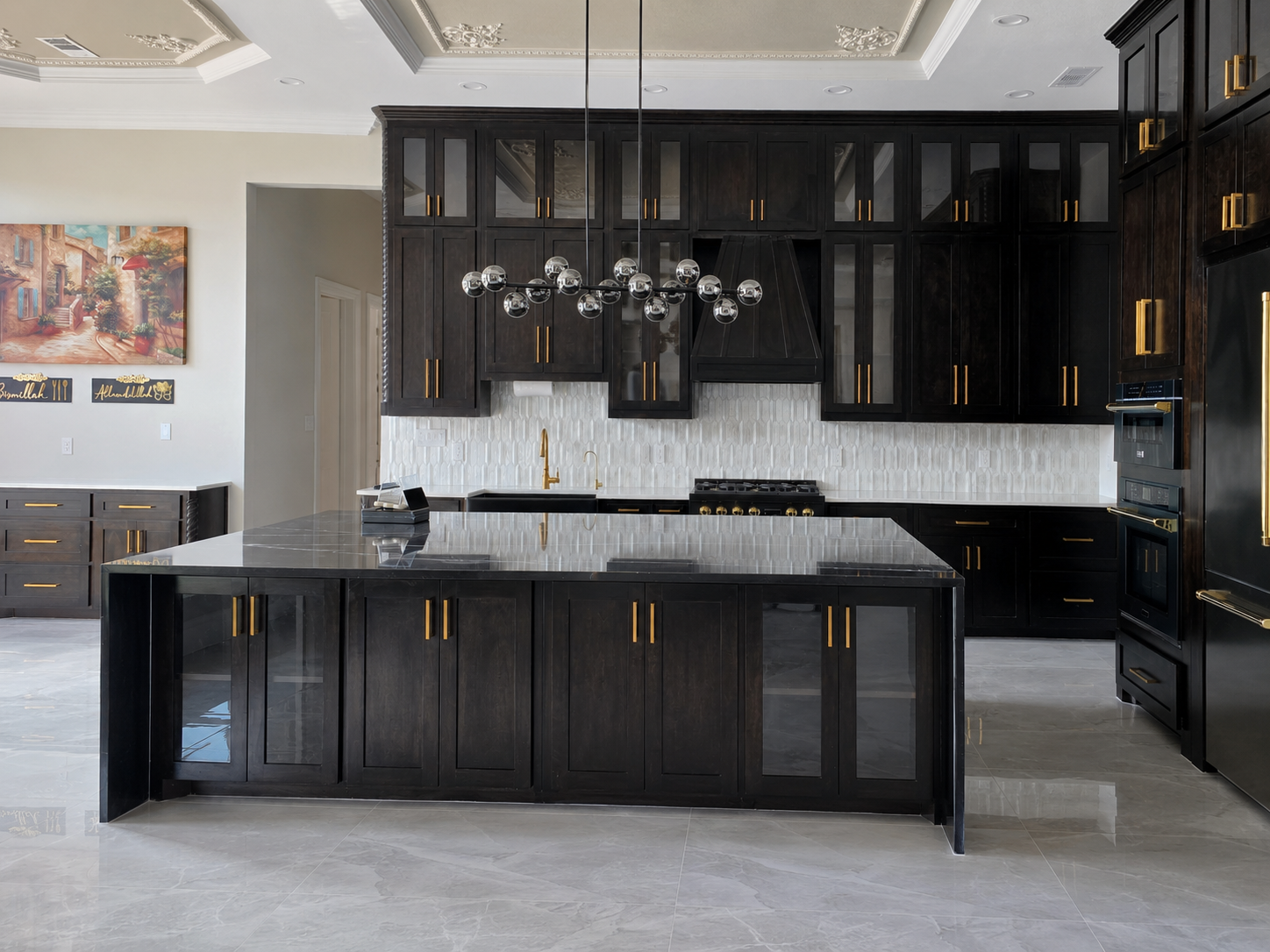 Custom kitchen inside a grand Mediterranean home with warm cabinetry and a large island