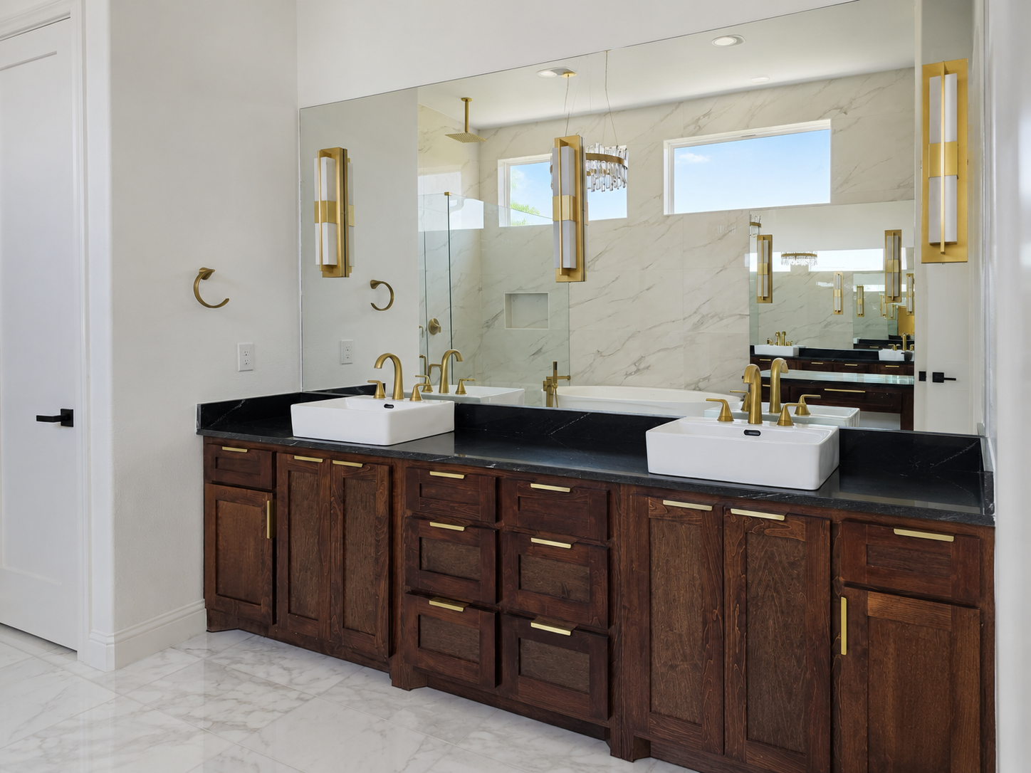 Modern transitional bathroom with double sinks and framed mirrors