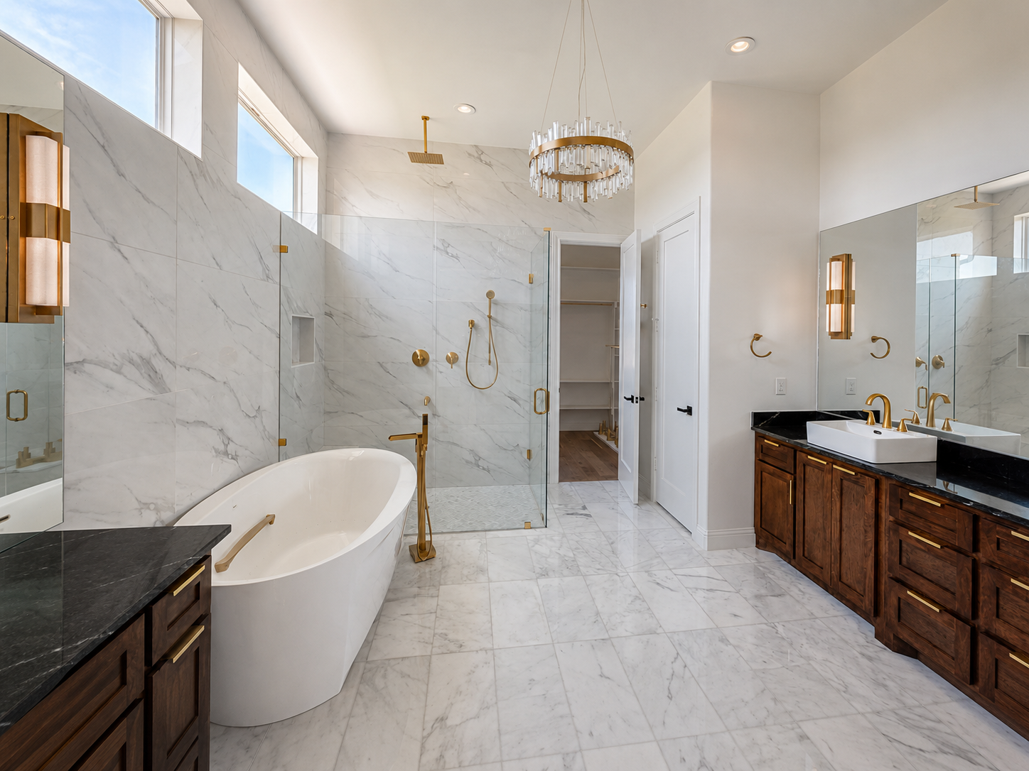 Custom bathroom with glass shower, tub, and warm finishes