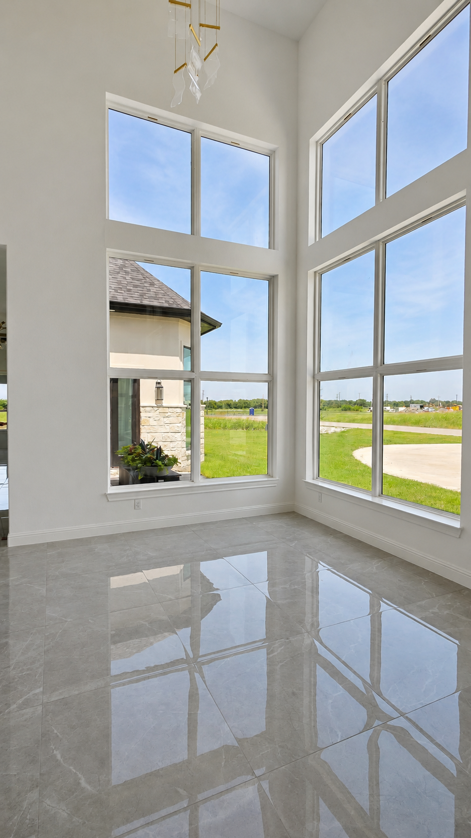 Tall black-framed windows inside a modern transitional custom home